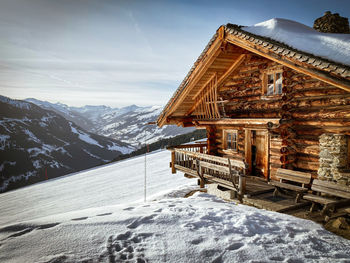 Built structure on snow covered mountain against sky