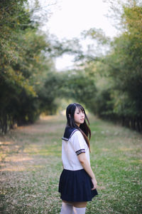 Side view portrait of young woman in bamboo groove