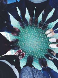 Low section of person standing on tiled floor