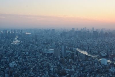 High angle view of buildings against sky during sunset