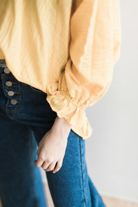 Low section of couple standing against white background