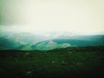 Scenic view of mountains against cloudy sky