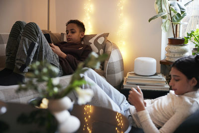 Portrait of woman using mobile phone at home