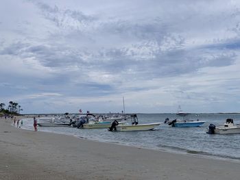 People on beach against sky