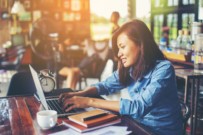 Woman sitting on table at cafe