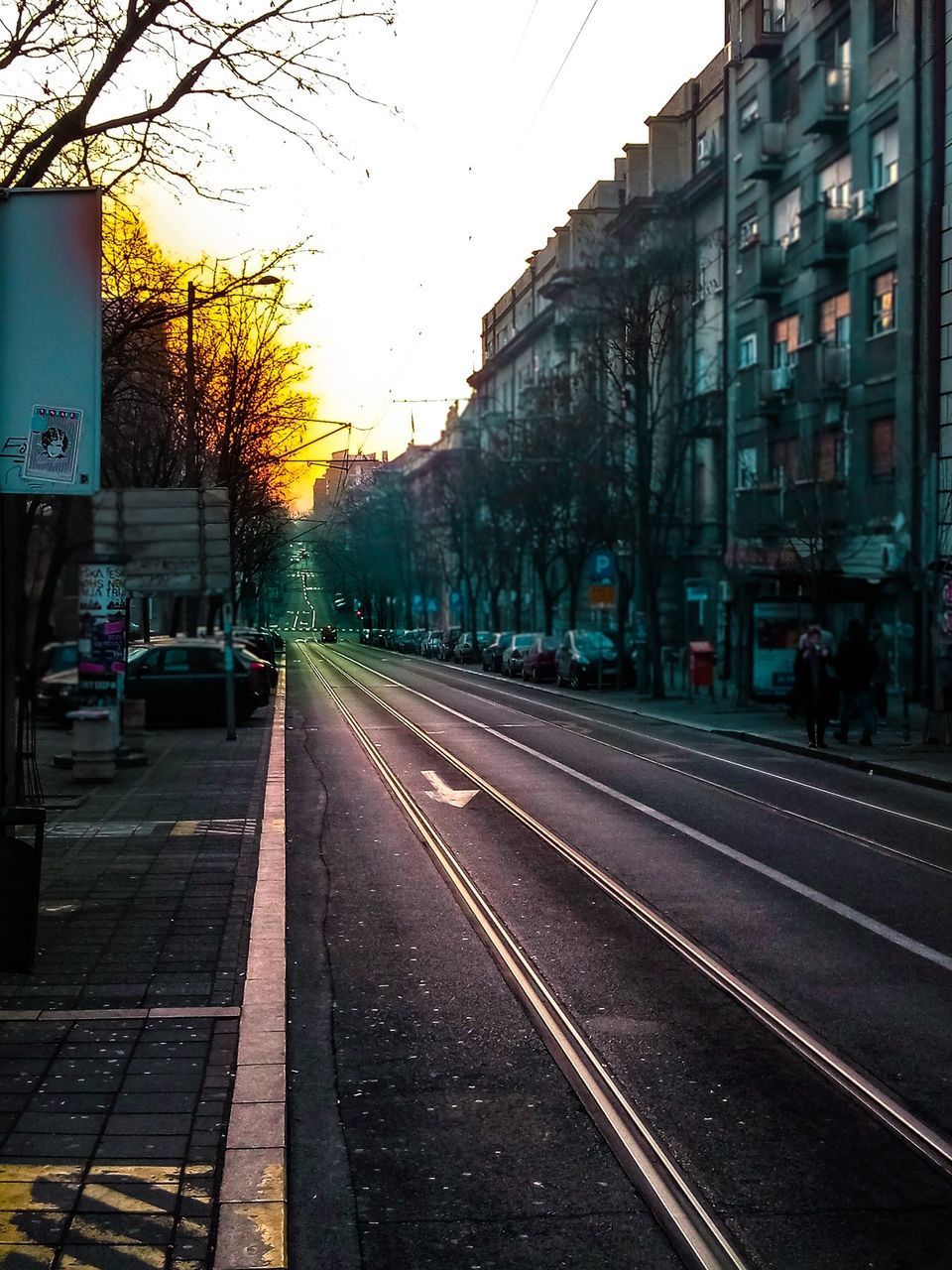 RAILROAD TRACKS AMIDST CITY AGAINST CLEAR SKY