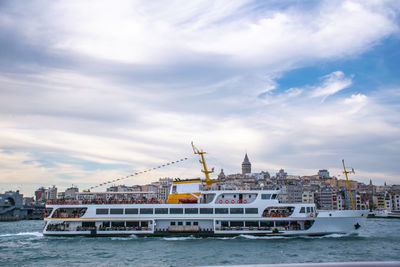 View of ship in sea against cloudy sky