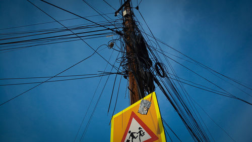 Low angle view of electricity pylon against sky