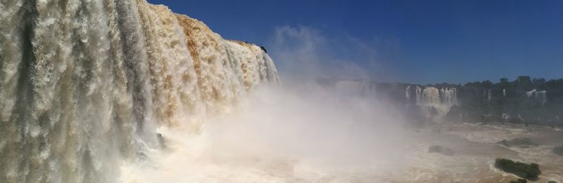 Low angle view of waterfall against sky