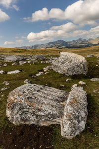 Aerial view of rocks on field against sky