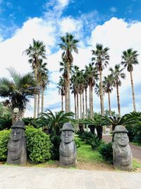 Palm trees in park against sky