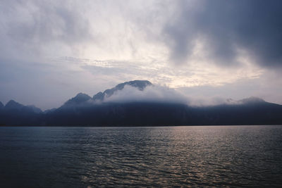 Scenic view of sea and mountains against sky