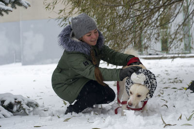 Girl playing with dog in winter