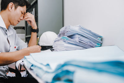 Midsection of man working on table