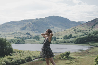 Woman standing against mountain