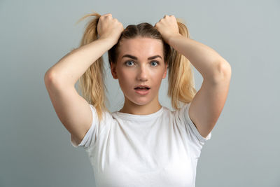 Portrait of a young woman against white background