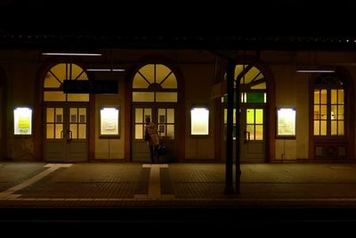 Man in illuminated building at night