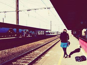 Woman walking on railroad station platform
