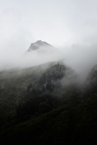 Scenic view of mountains in the fog