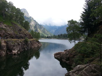 Scenic view of lake and mountains against sky