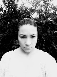 Portrait of woman standing against plants