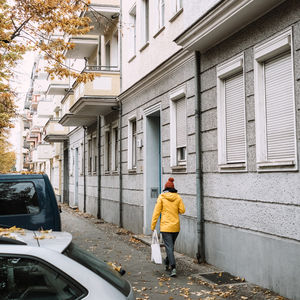 Full length rear view of man walking in city