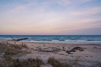Scenic view of beach against sky during sunset