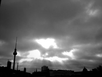 Low angle view of buildings against cloudy sky