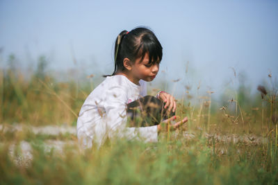 Side view of girl on field