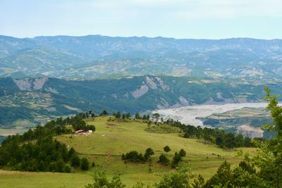 Scenic view of landscape and mountains against sky