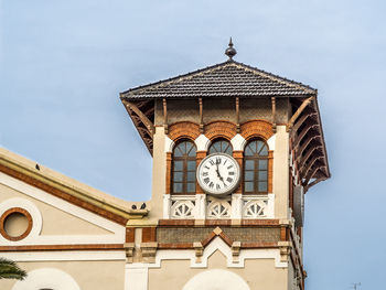 Low angle view of clock tower against clear sky