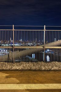 Bridge over river against sky at night