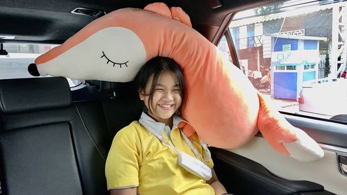 Portrait of smiling young woman in car