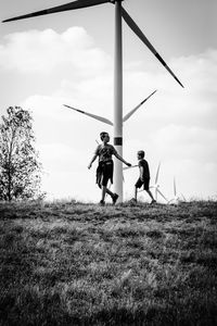 Kids playing under windmills