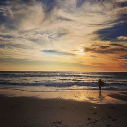 Scenic view of beach against sky during sunset