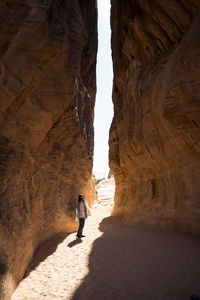 Side view of anonymous traveler enjoying sight the edge of the world during vacation in saudi arabia