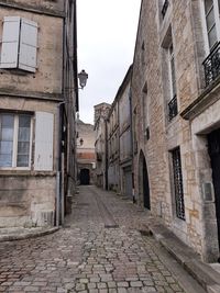 Street amidst buildings against sky