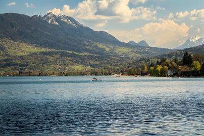 Scenic view of lake and mountains against sky