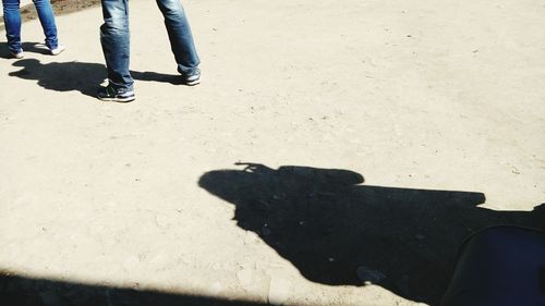 Low section of people standing on tiled floor