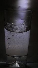 Close-up of water drops on glass table