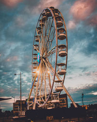 Low angle view of ferris wheel against sky