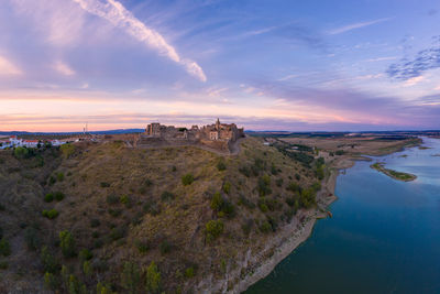 Juromenha castle, village and guadiana river drone aerial view at sunset in alentejo, portugal