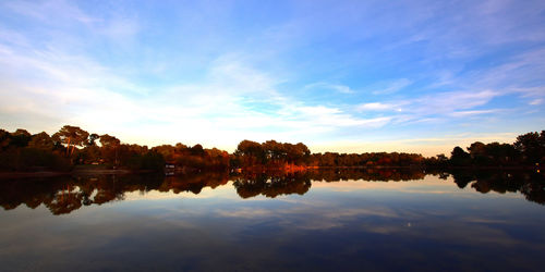 Scenic view of lake against sky at sunset