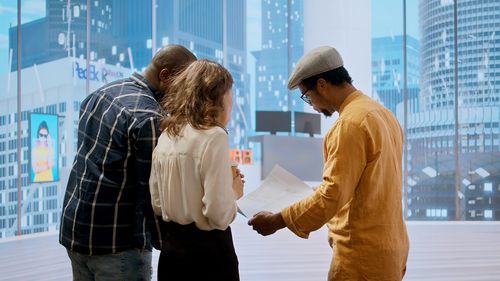 Rear view of couple standing in city