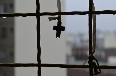 Close-up of metal gate against sky