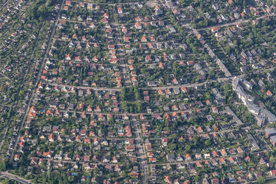 High angle view of field and buildings in city