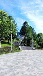 Footpath in park against sky