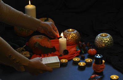 High angle view of hand holding candles on table