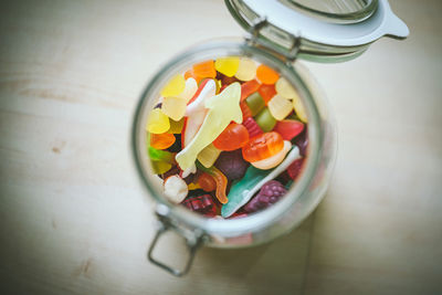 High angle view of colorful candies in jar on table