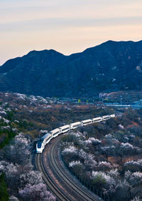 High angle view of railroad tracks and mountains in spring